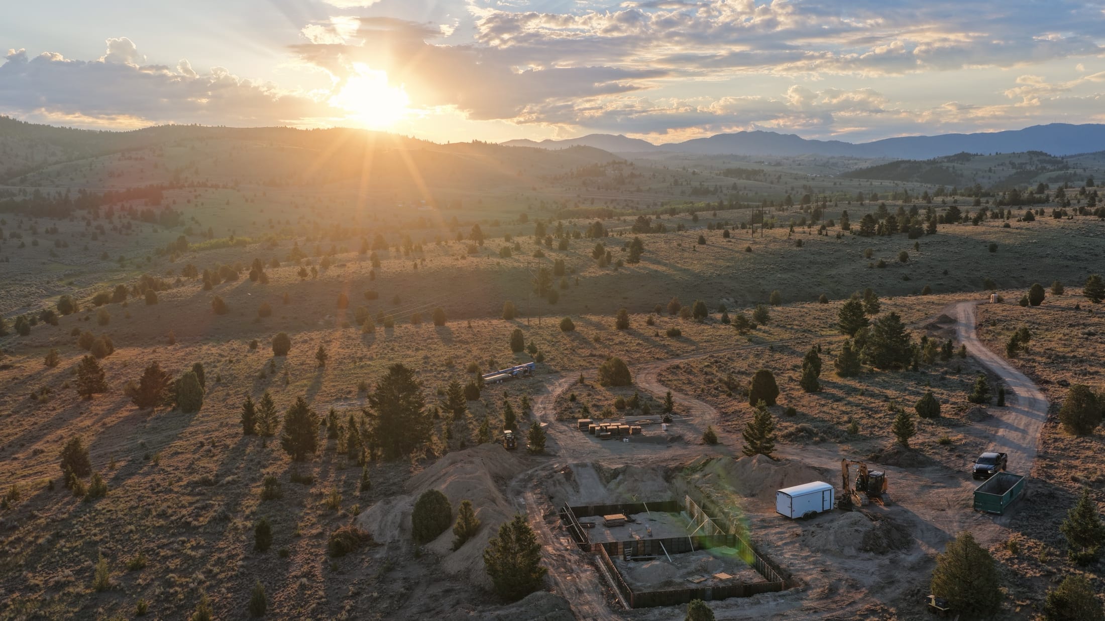 A foundation going in on open Montana land at sunset